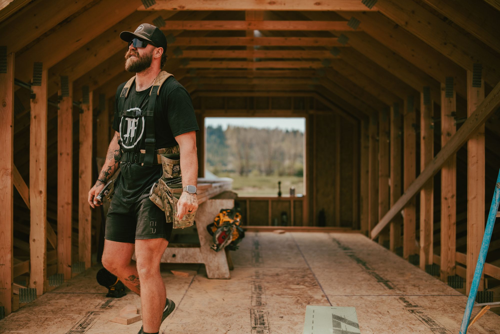An IB carpenter walking through the framed space