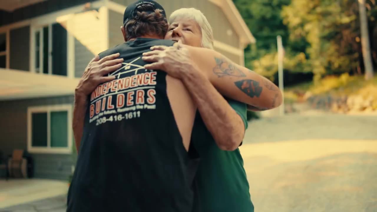 Jaquie B. hugging James Benson outside her home